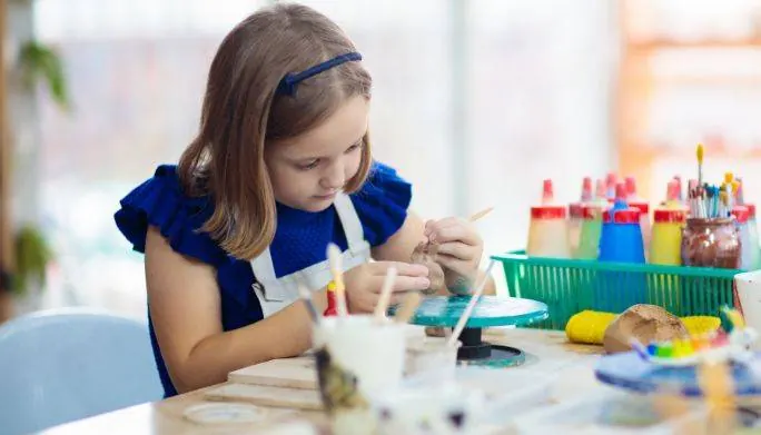 Young girl working on a craft project as part of pediatric occupational therapy