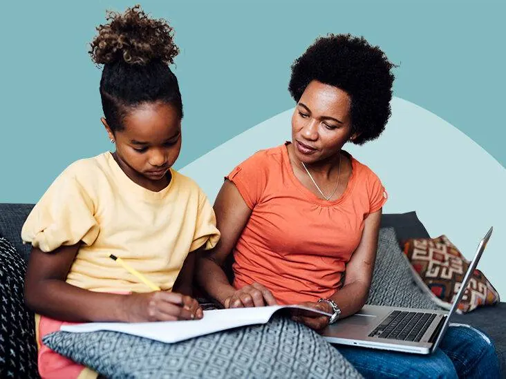 Parent helping a child with schoolwork at home, part of a family-supported therapy routine