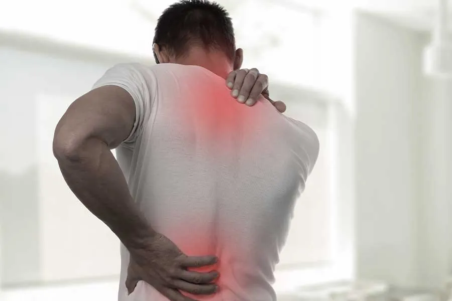 Man holding his lower back and shoulder in pain