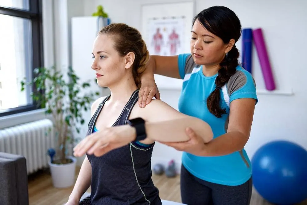 Physical therapist guiding a patient through a pelvic floor therapy session