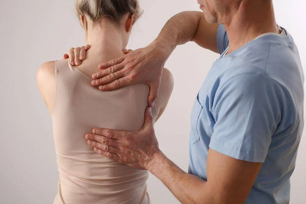 Physical therapist providing hands-on manual therapy to an athlete's neck