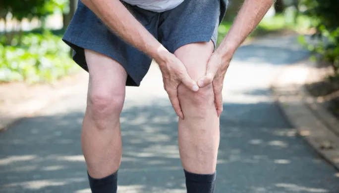 Physical therapist assessing a patient's knee and ACL stability