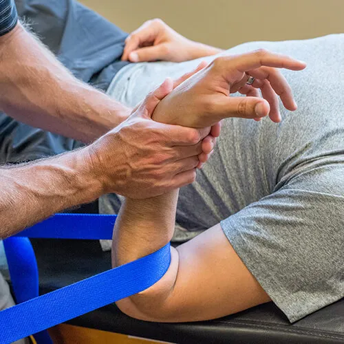 Therapist working with a patient on wrist and hand rehabilitation