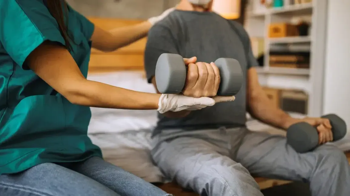 Physical therapist examining a patient's wrist and arm
