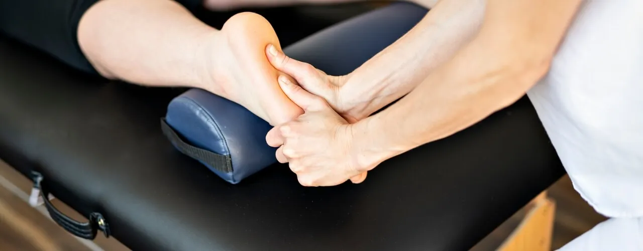 Therapist performing manual therapy on a patient's foot and ankle