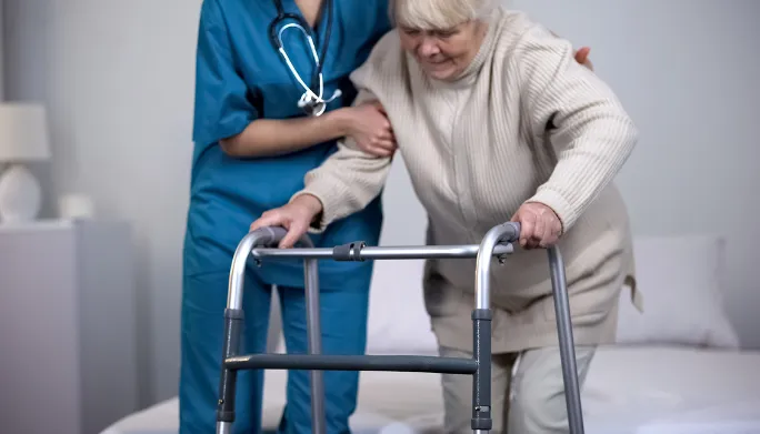 Physical therapist guiding a patient through early hip replacement rehabilitation