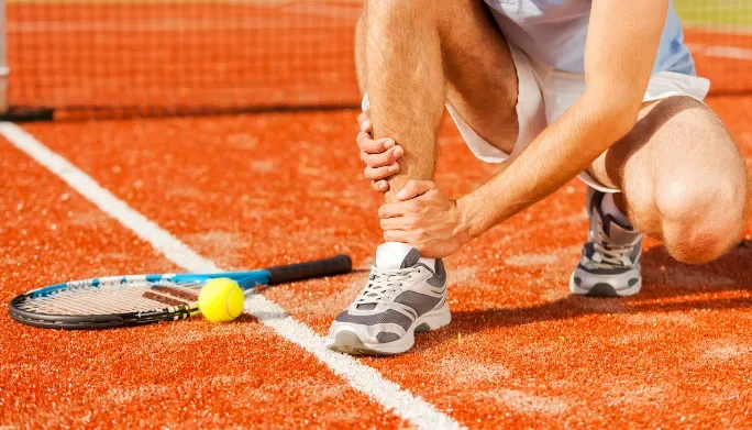 Athlete holding their arm after a sports injury